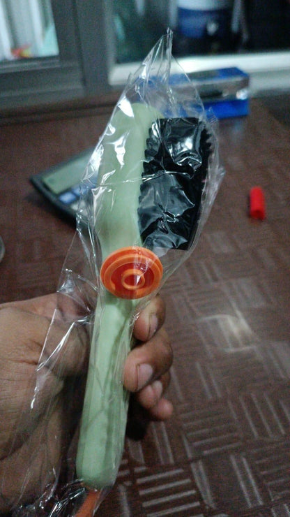 Hand holding a multifunctional shoe brush in packaging for cleaning various shoe types