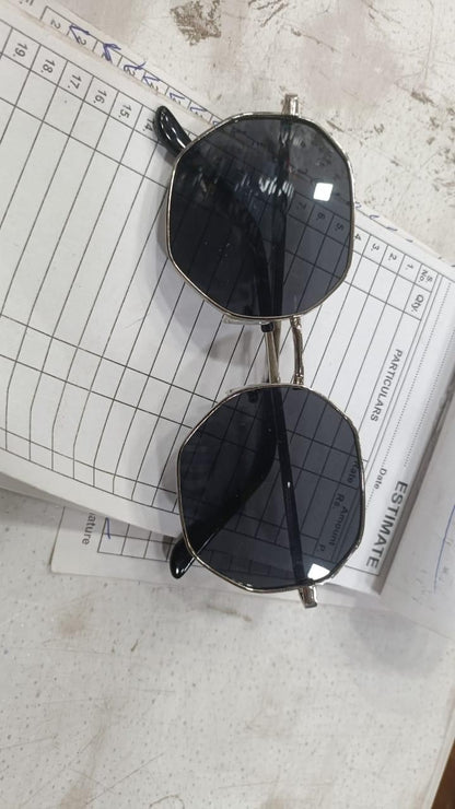 Unique octagon sunglasses with black lenses and stylish metal frame laid on an estimate paper